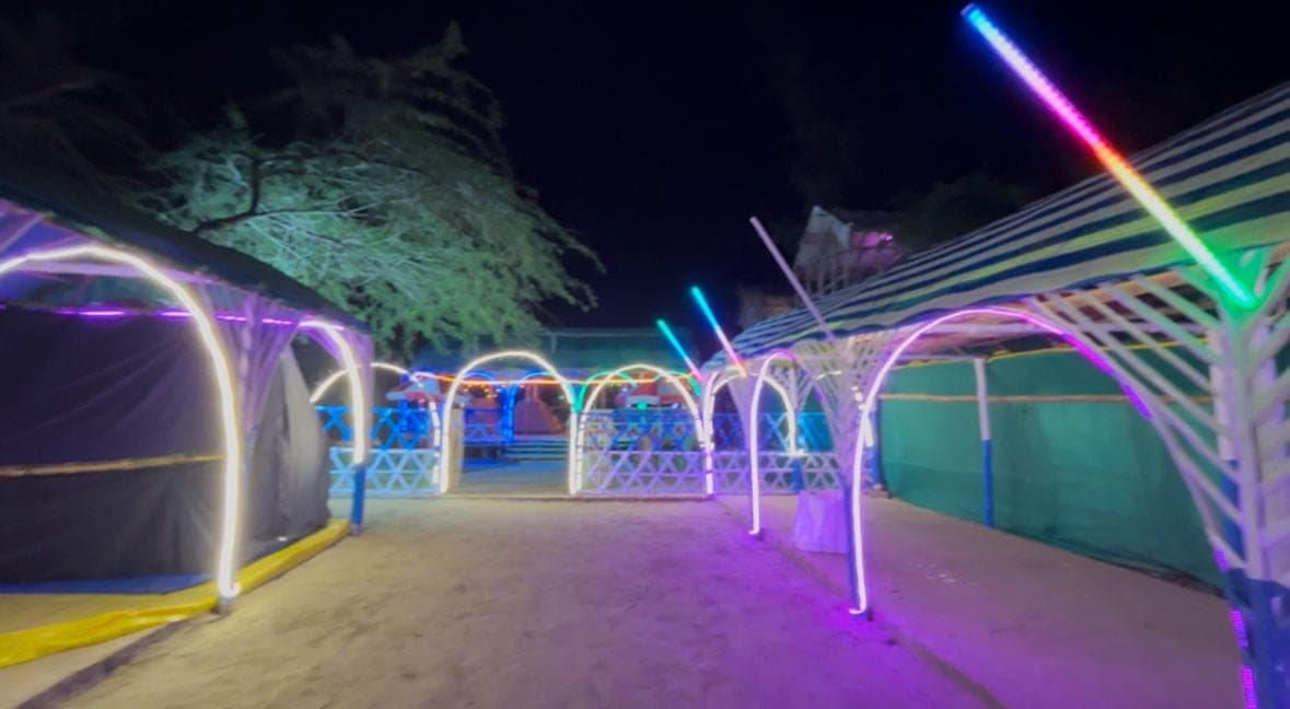 Outdoor camp structures lit at night