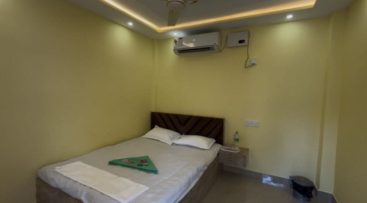 One-bed room looking toward the bed and air-conditioner