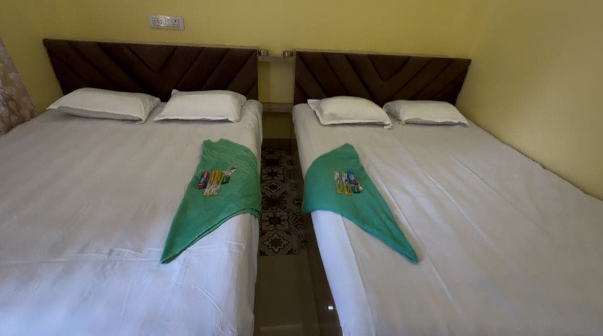 Two beds side by side in a Honey Dew Beach Camp room